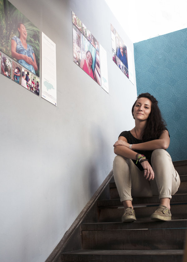 Giulia Vuillermoz (27), EUAV in Communication in Honduras, sits next to some of the pictures from her photo exhibition Behind the Scenes: Women Defenders of Live, in the Cultural Centre Bocaloba, Photo: Mayra Oyuela
